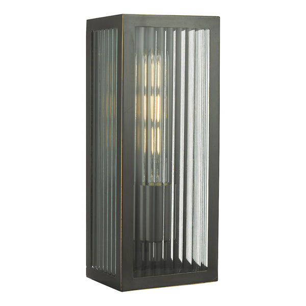 Rectangular wall light with a dark metal frame and fluted glass panels, housing a visible filament bulb