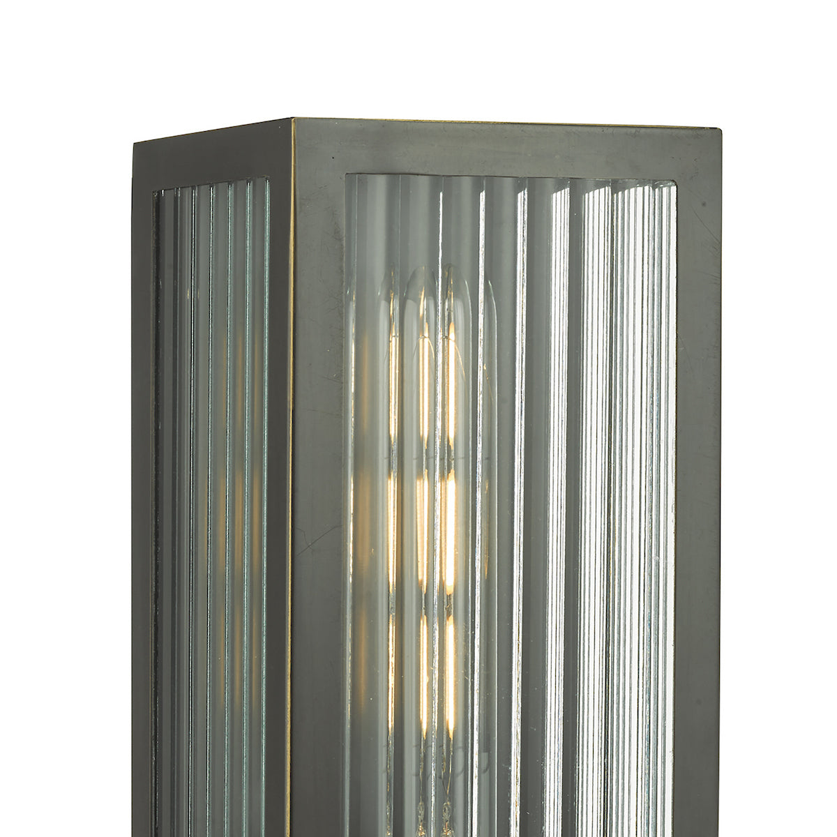 Close-up of a rectangular wall light with fluted glass panels and a visible bulb