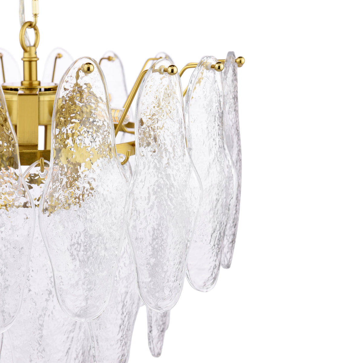 Close up of a brass chandelier with textured glass panels