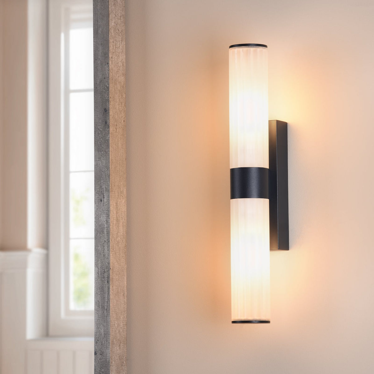 Black and white wall sconce with two cylindrical lights