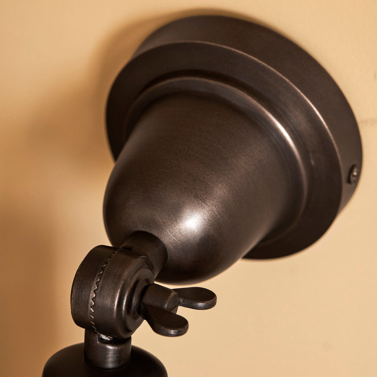 Detail of the adjustable hinge on the Longborough wall spotlight in antique bronze