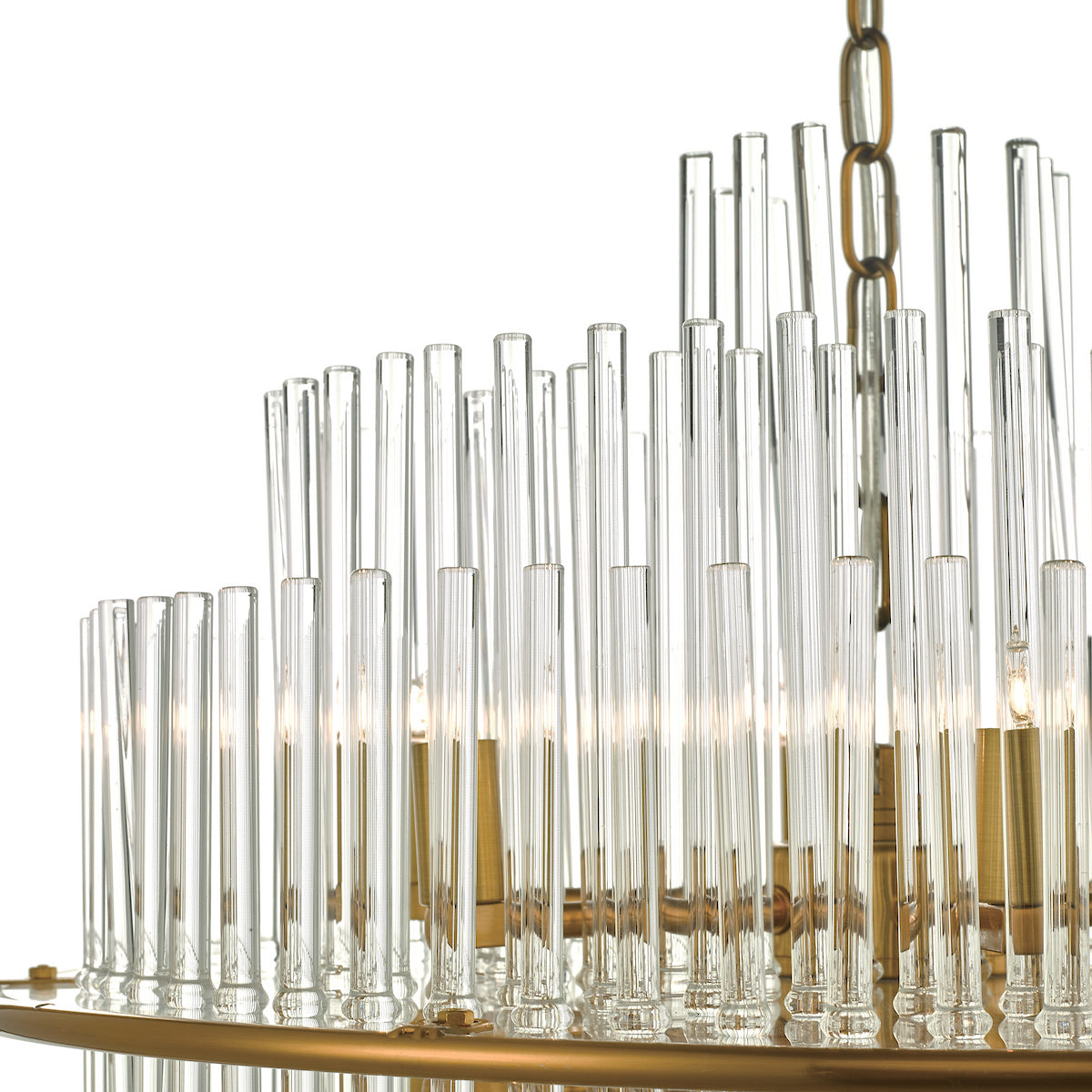 Close-up of a tiered chandelier with clear glass rods and brass accents, illuminated from within.
