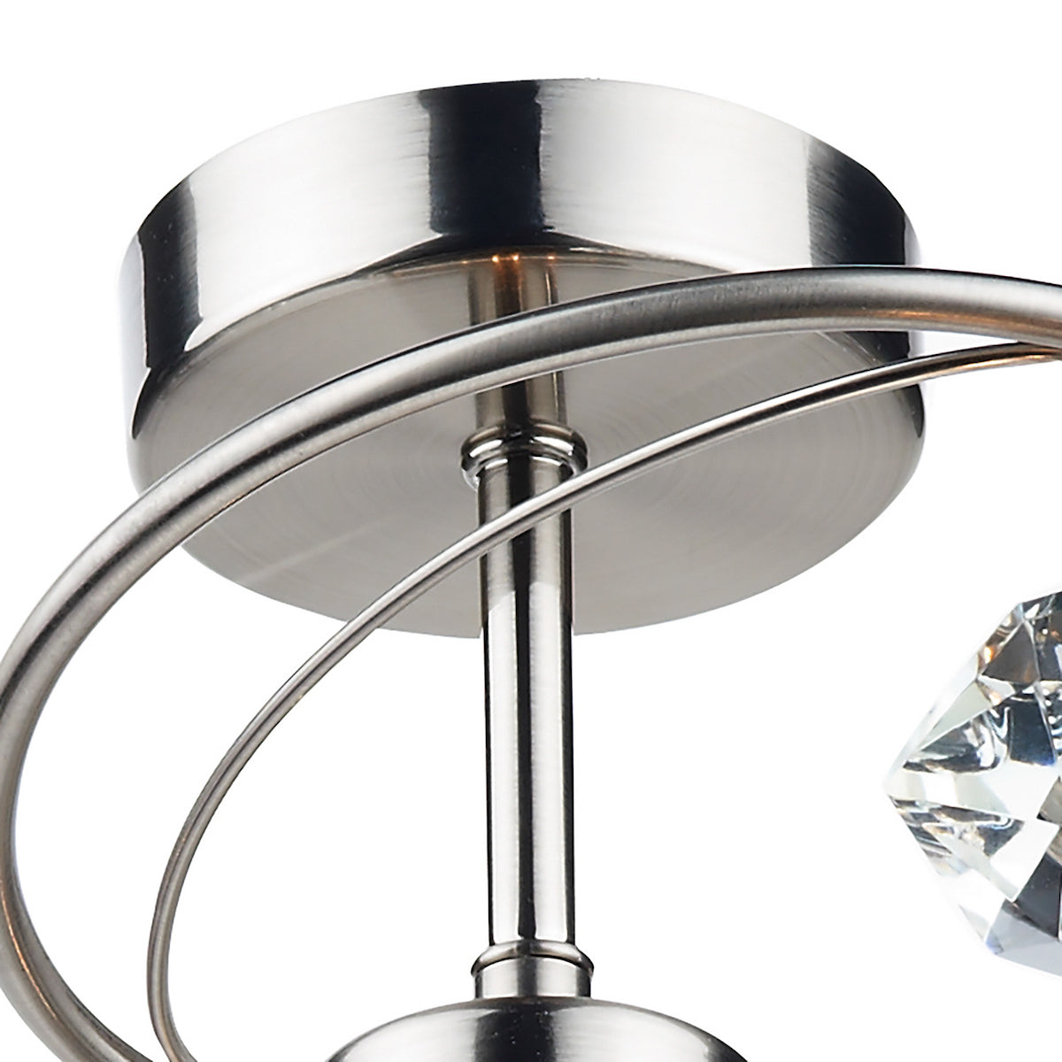 Close-up of a brushed nickel light fixture with a crystal accent.