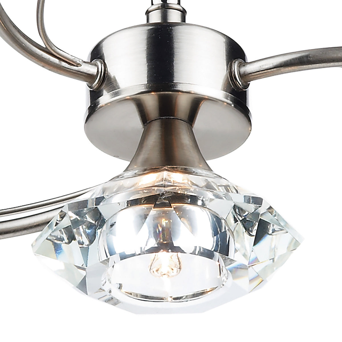 Close-up of a brushed nickel light fixture with a faceted crystal shade and exposed bulb.