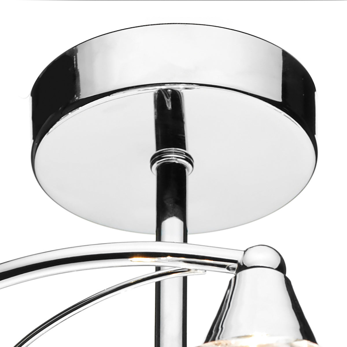 Close-up of a chrome ceiling light fixture with a round base and curved arms.