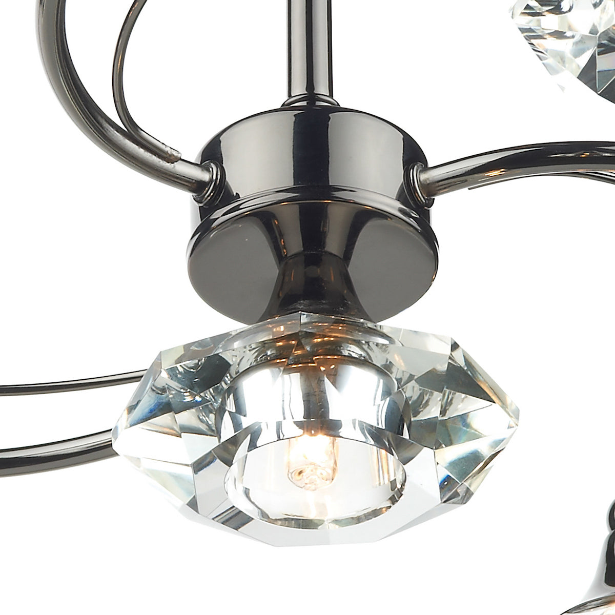 Close-up of a chandelier with a polished dark metal base and a faceted clear crystal light fixture.