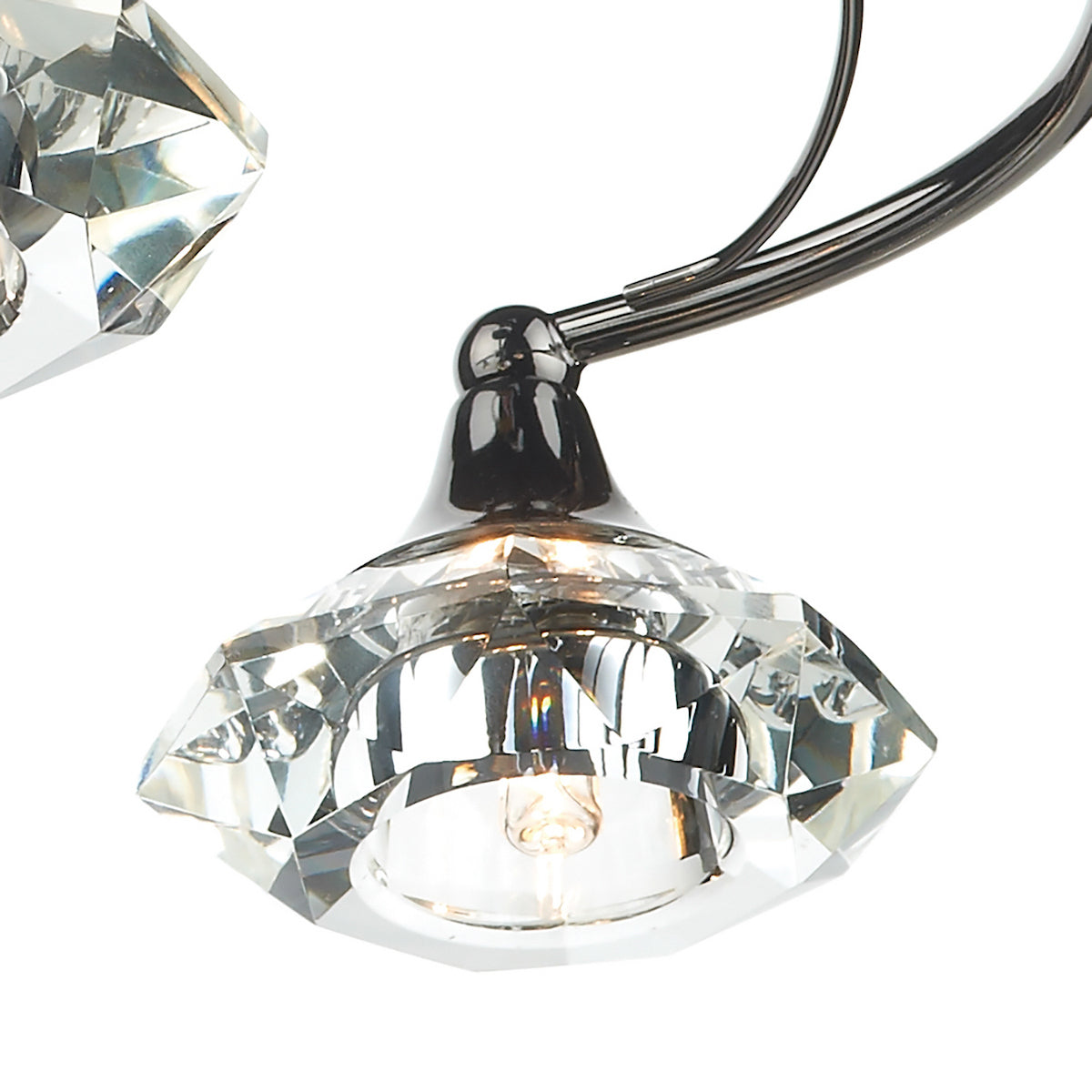 Close-up of a crystal light fixture with a clear bulb and dark metal arm.