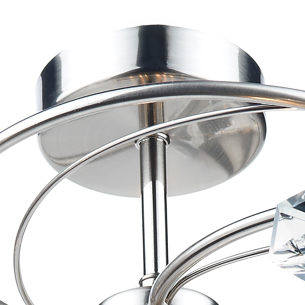 Close-up of a modern ceiling light fixture with brushed nickel finish and crystal accents.