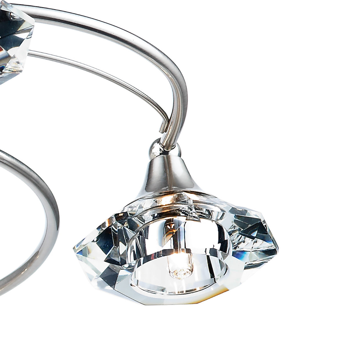 Close-up of a modern chandelier with a polished chrome finish and faceted crystal shades.
