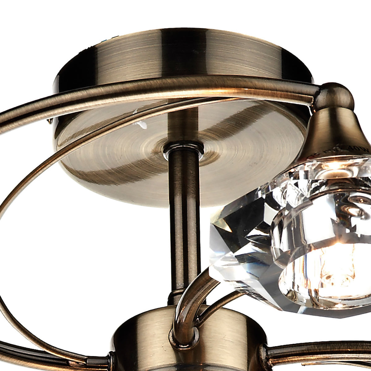 Close-up of a bronze ceiling light with a faceted crystal shade and exposed bulb.