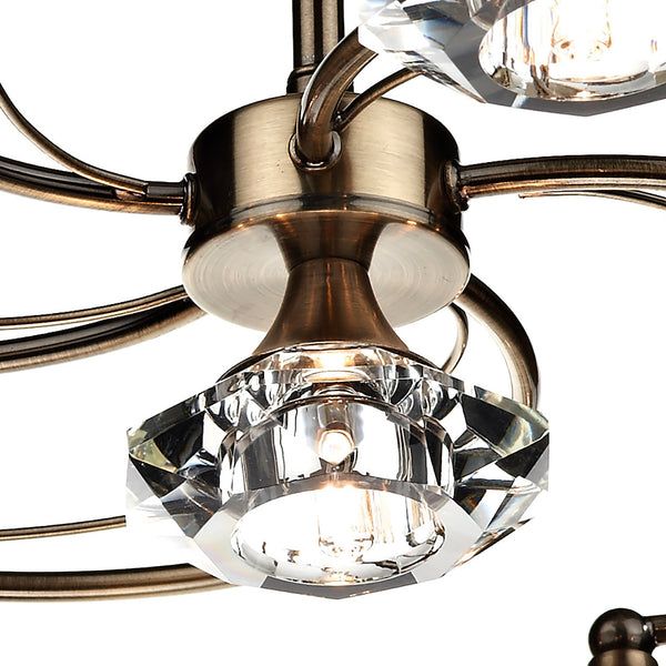 Close-up of a bronze chandelier with clear, faceted crystal accents and glowing bulbs.