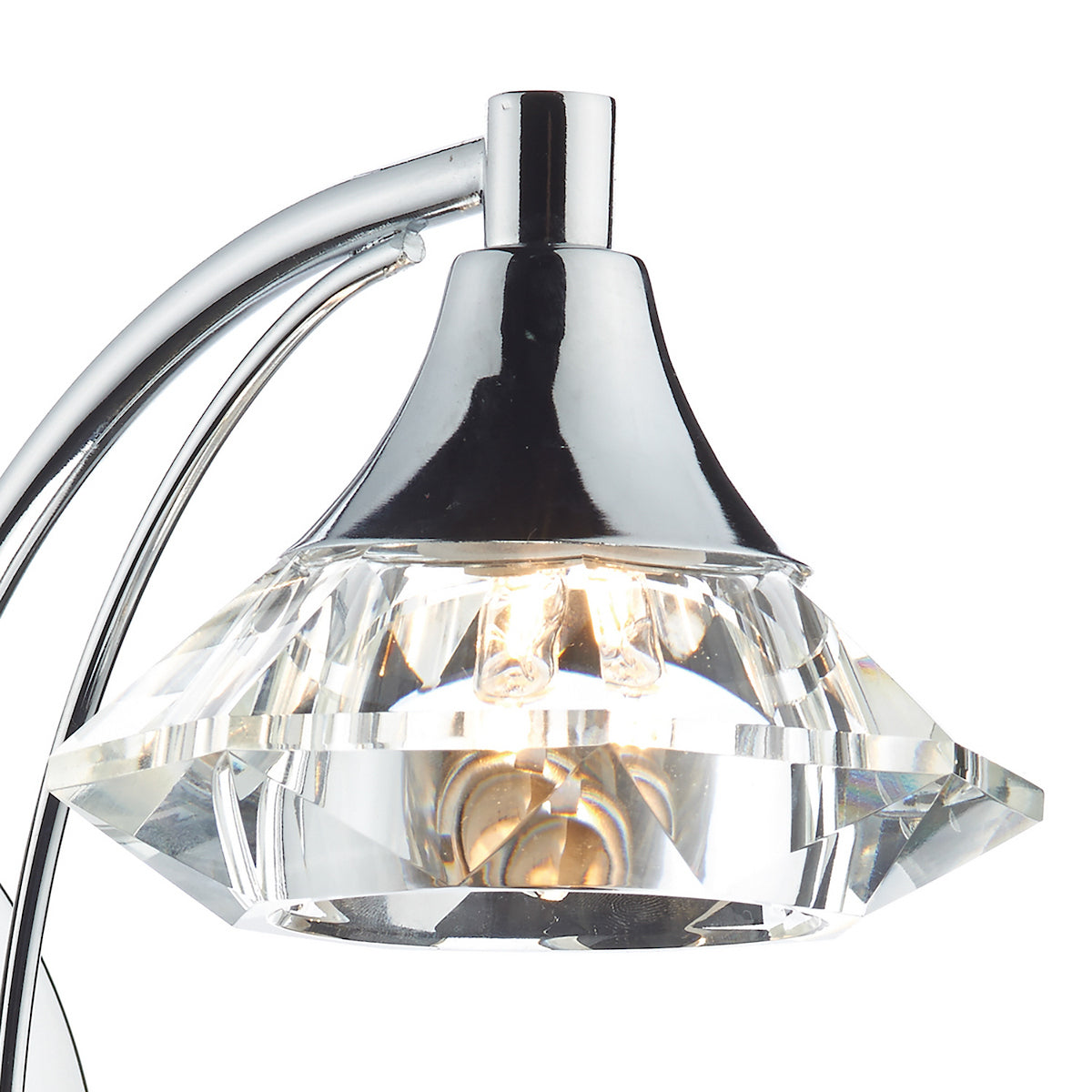 Close-up of a chrome light fixture with a faceted crystal shade.
