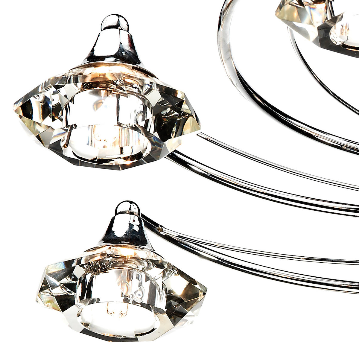 Close-up of a modern chandelier with faceted crystal shades and chrome accents.