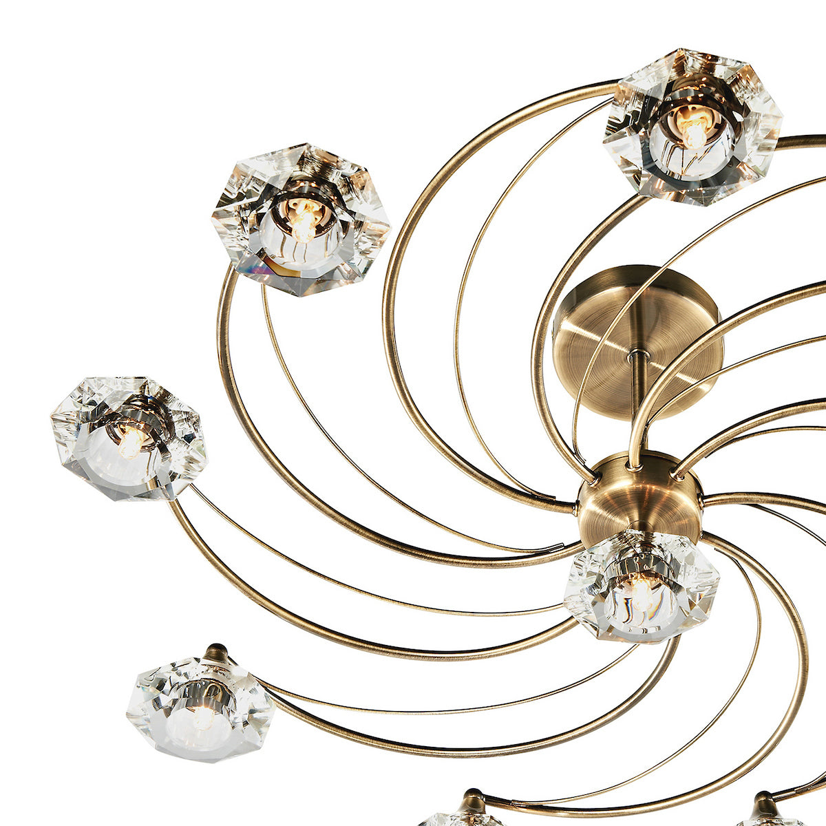 Close-up of a modern chandelier with brass arms and faceted crystal shades.