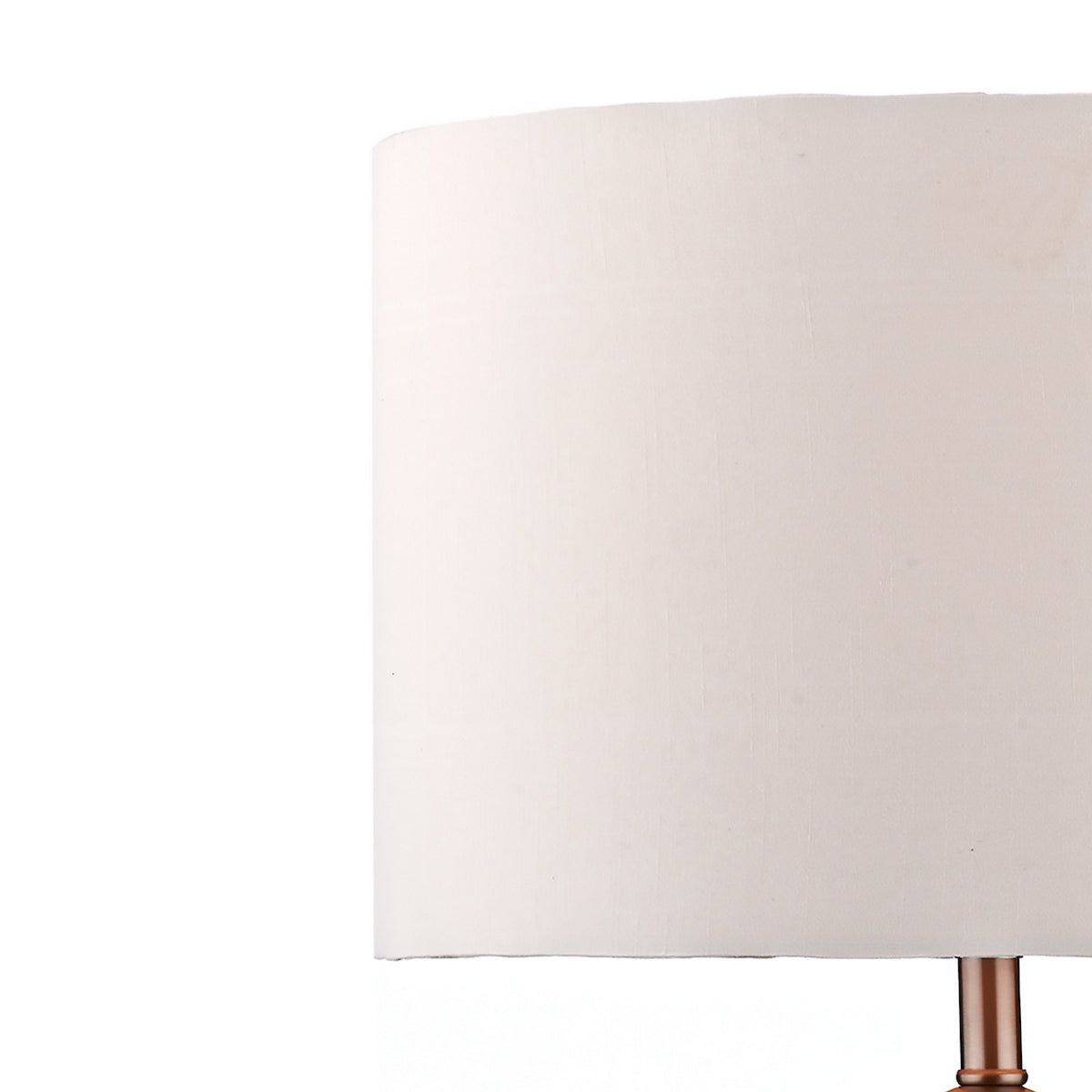 Close-up of a white lamp shade with a copper-colored base.