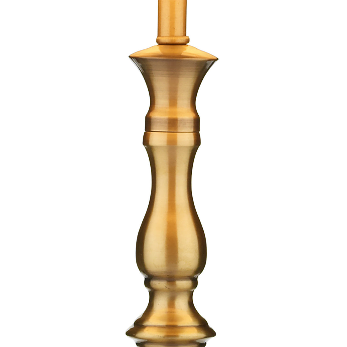 A close-up of a brass-colored metal lamp base with a decorative, curved design.