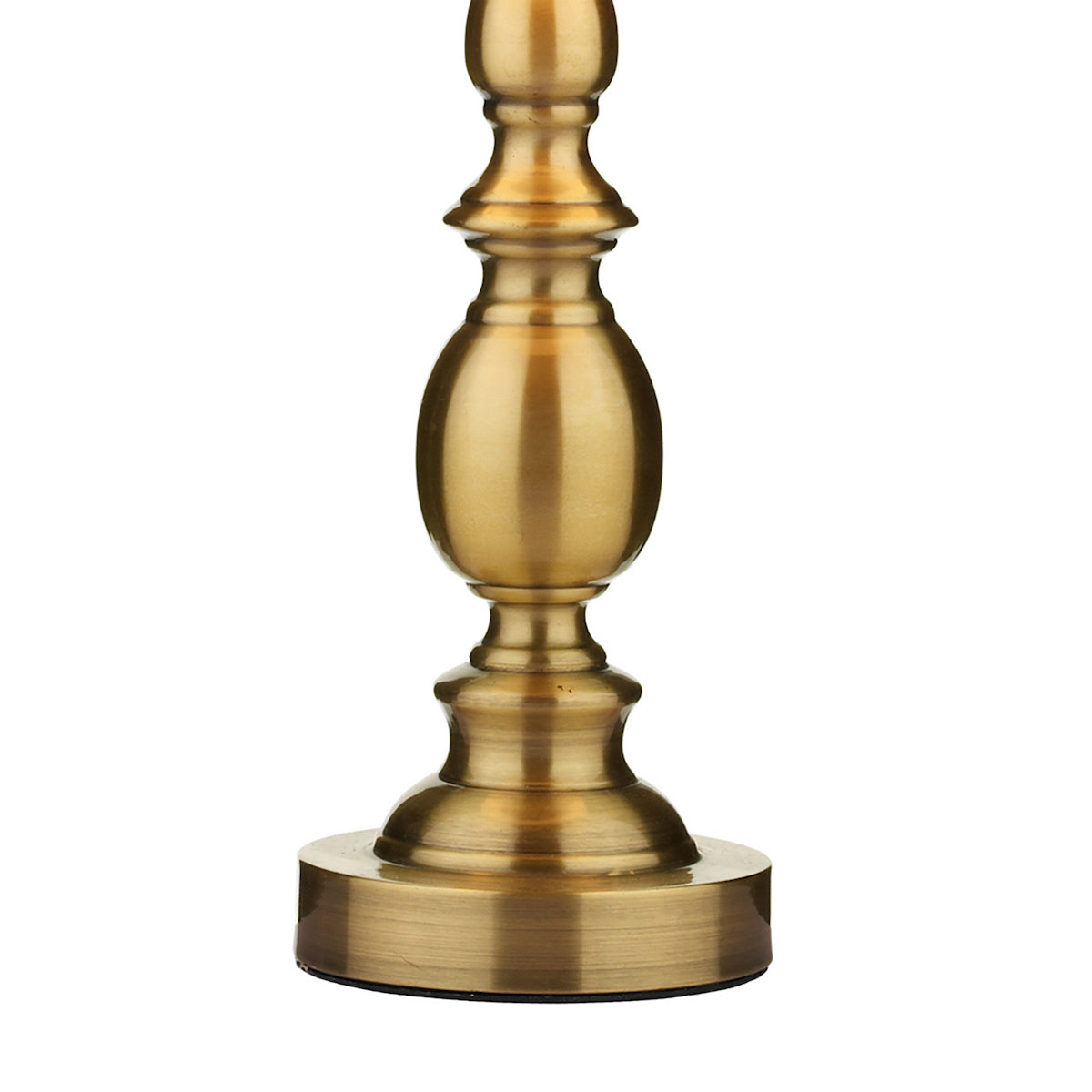 Close-up of a brass lamp base with a decorative, turned design.