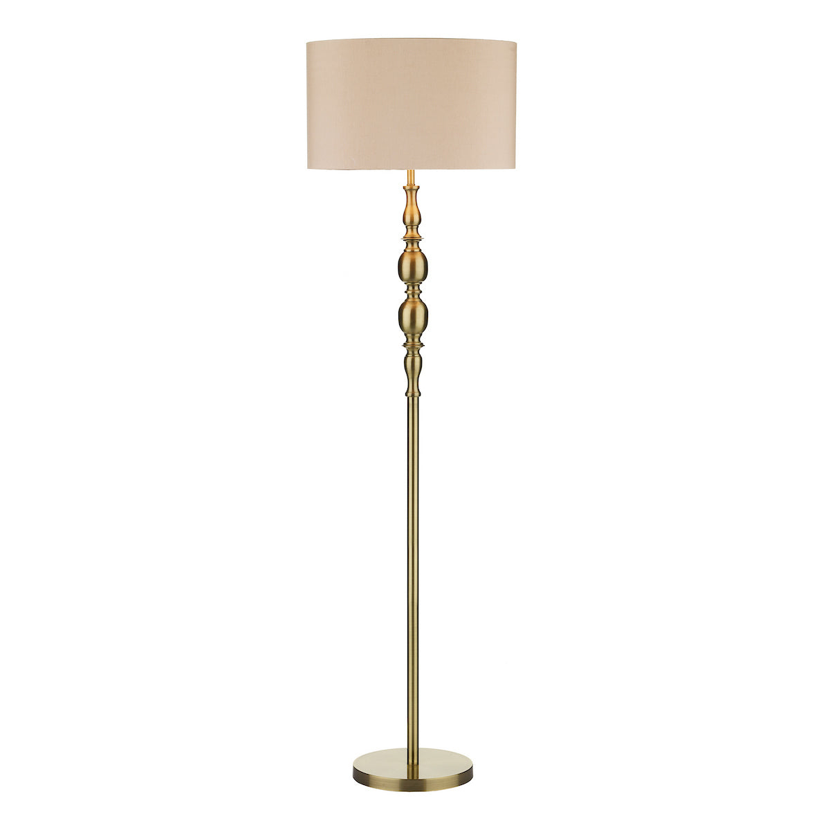 A tall, elegant brass floor lamp with a beige fabric drum shade on a white background.