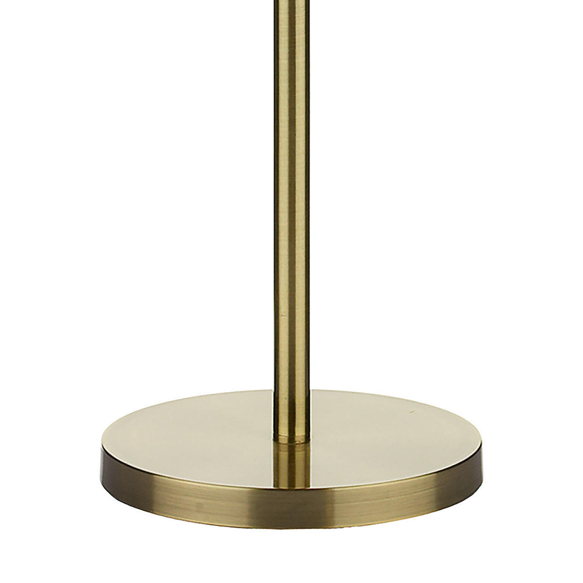 Close-up of a brushed brass lamp base and pole on a white background.