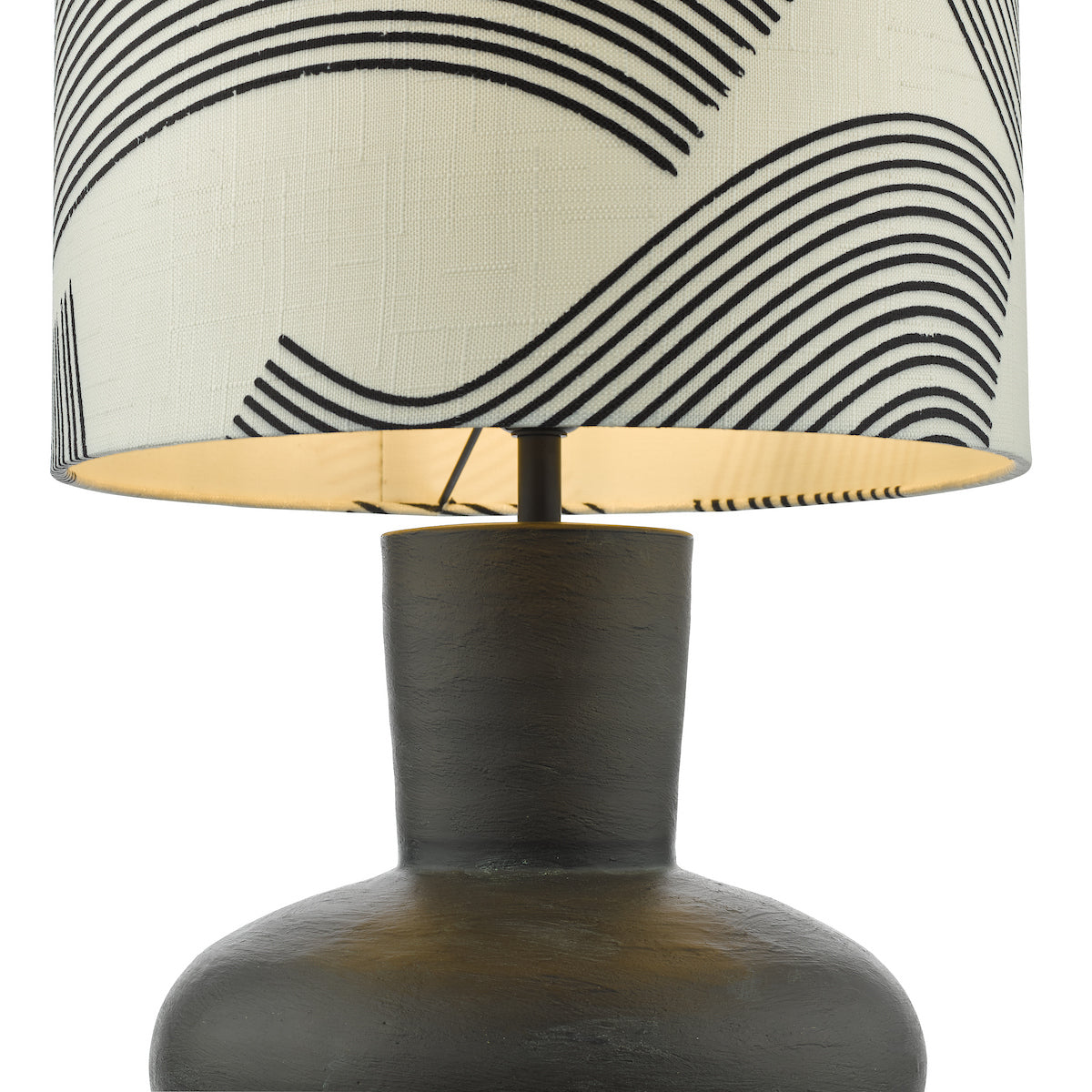Close-up of a table lamp with a dark, textured base and a white shade with black wavy lines.