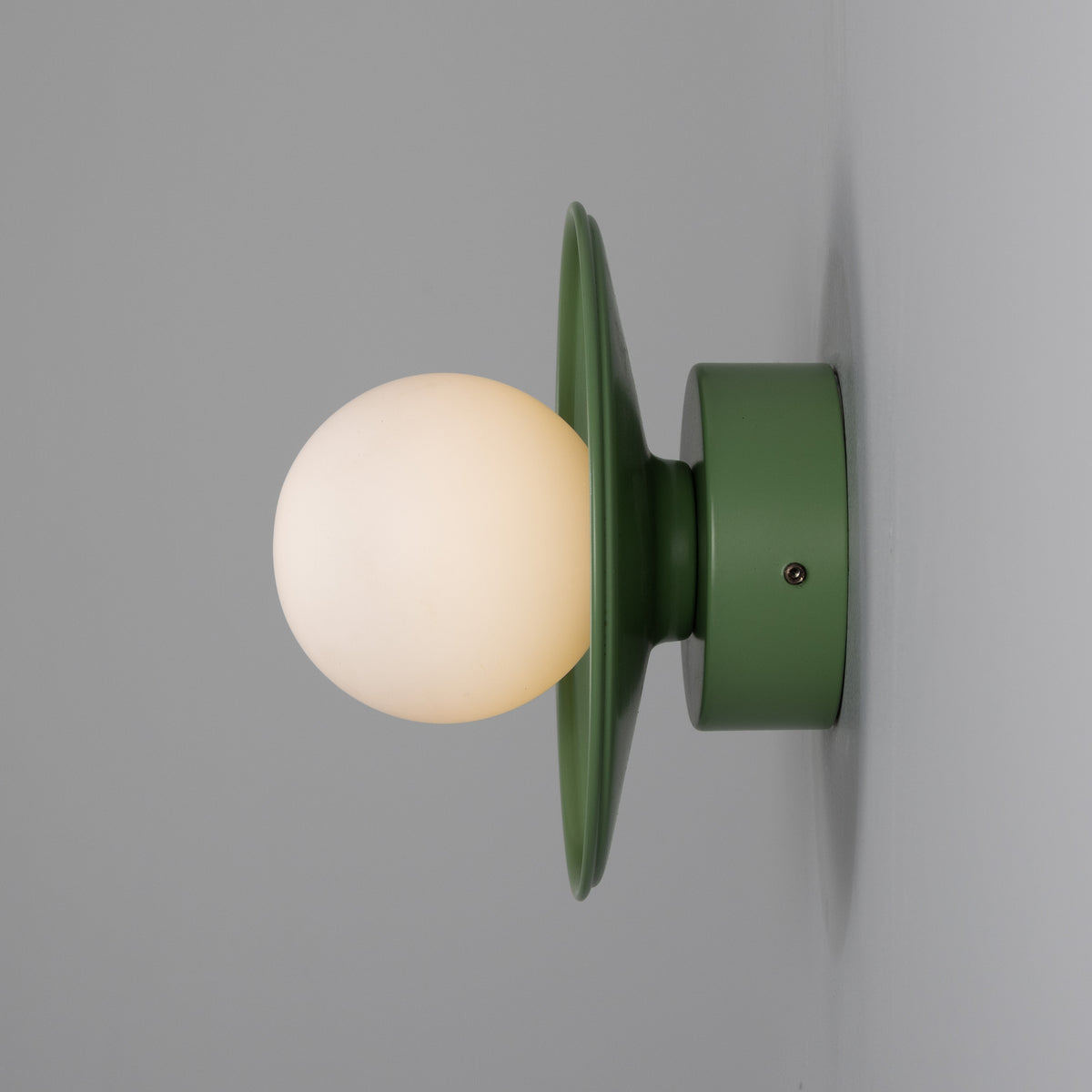 Aosta IP65 Brass Disc Bathroom Wall Light in Sage Green with Opal Glass Globe