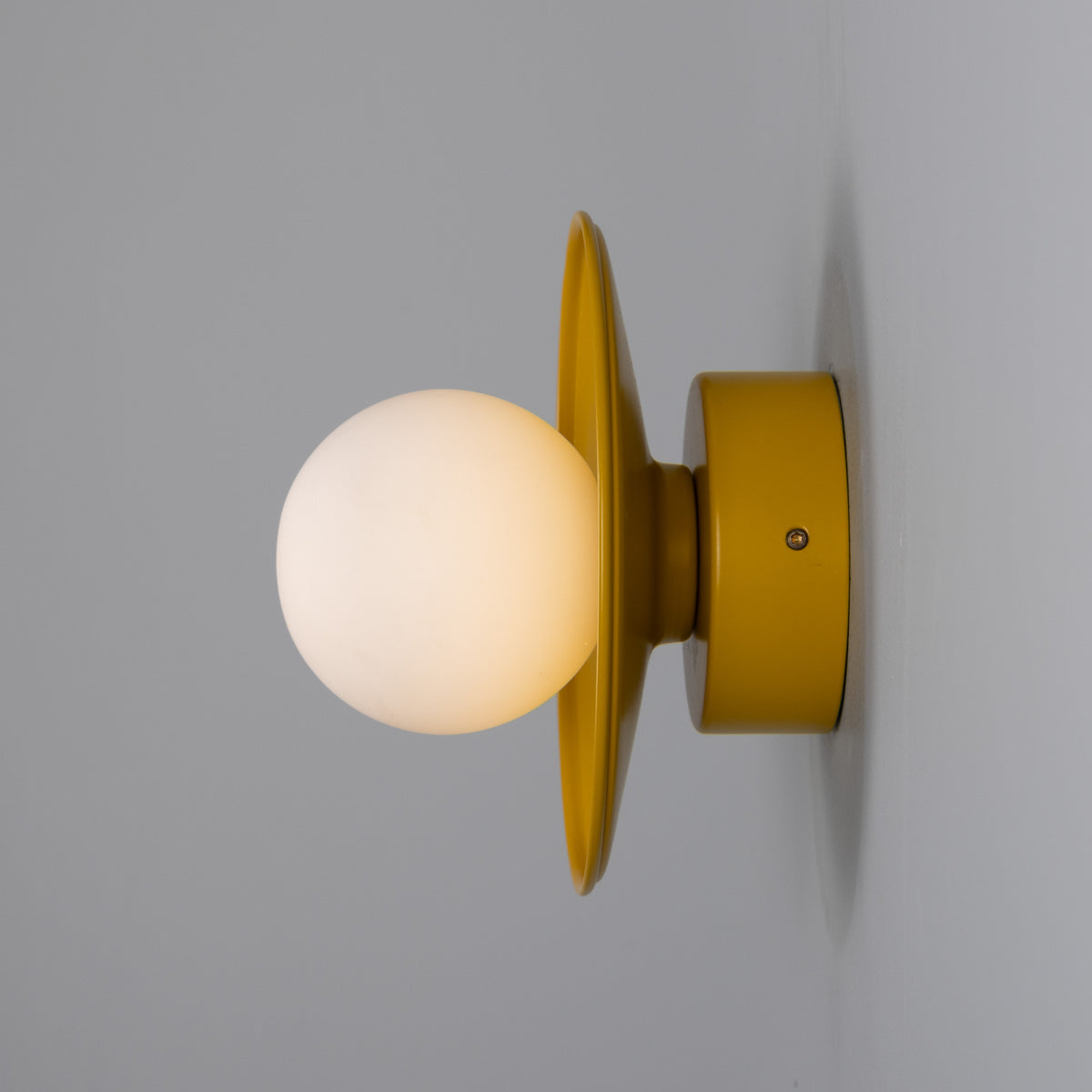 Aosta IP65 Brass Disc Bathroom Wall Light in Honey Yellow with Opal Glass Globe