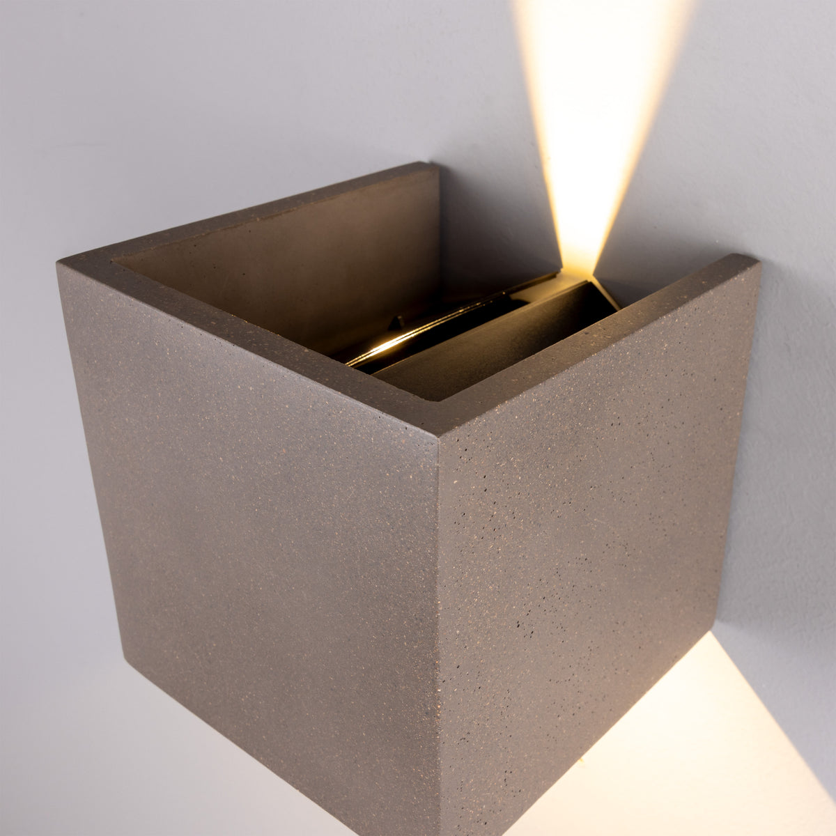 Mullan Marseille concrete LED wall light with adjustable up and down beams mounted on a wall
