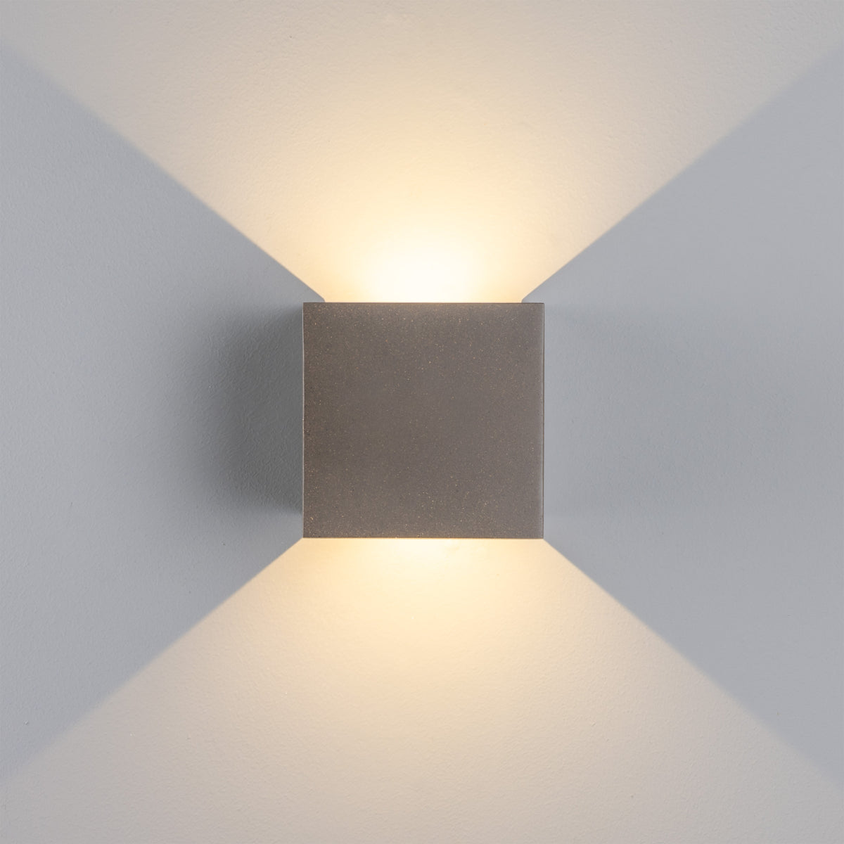 Mullan Marseille concrete LED wall light casting adjustable up and down light beams on a wall