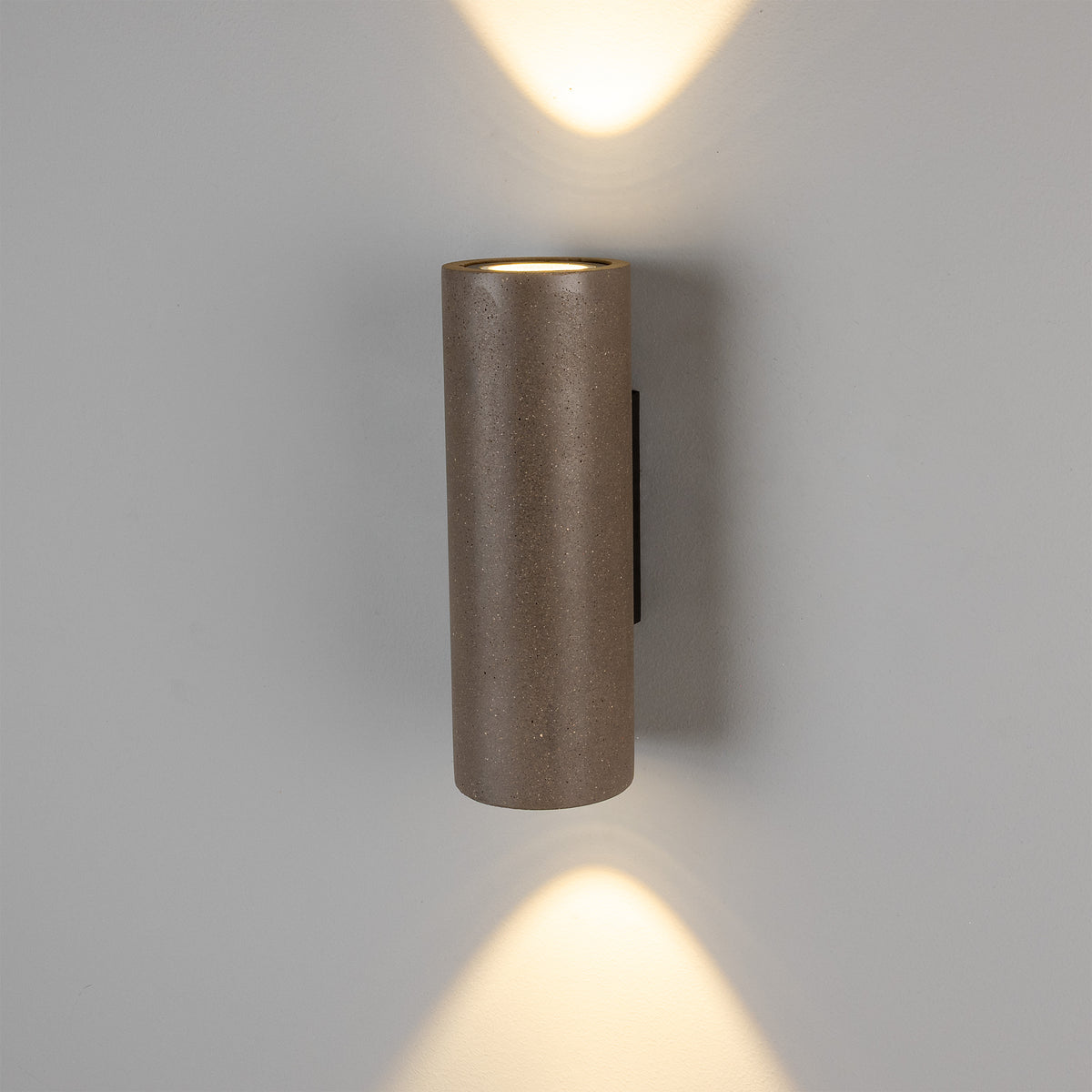 Mullan Pudong cylindrical concrete LED wall light with up and down lighting on a grey wall