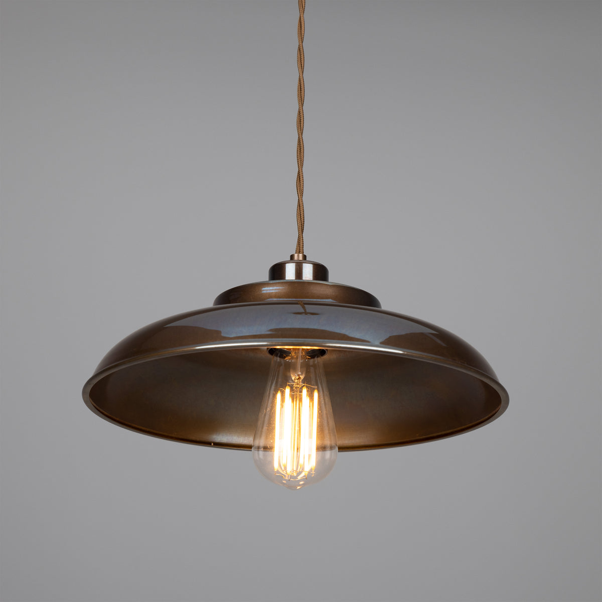 Bronze metal dome pendant light with exposed filament bulb and braided cord