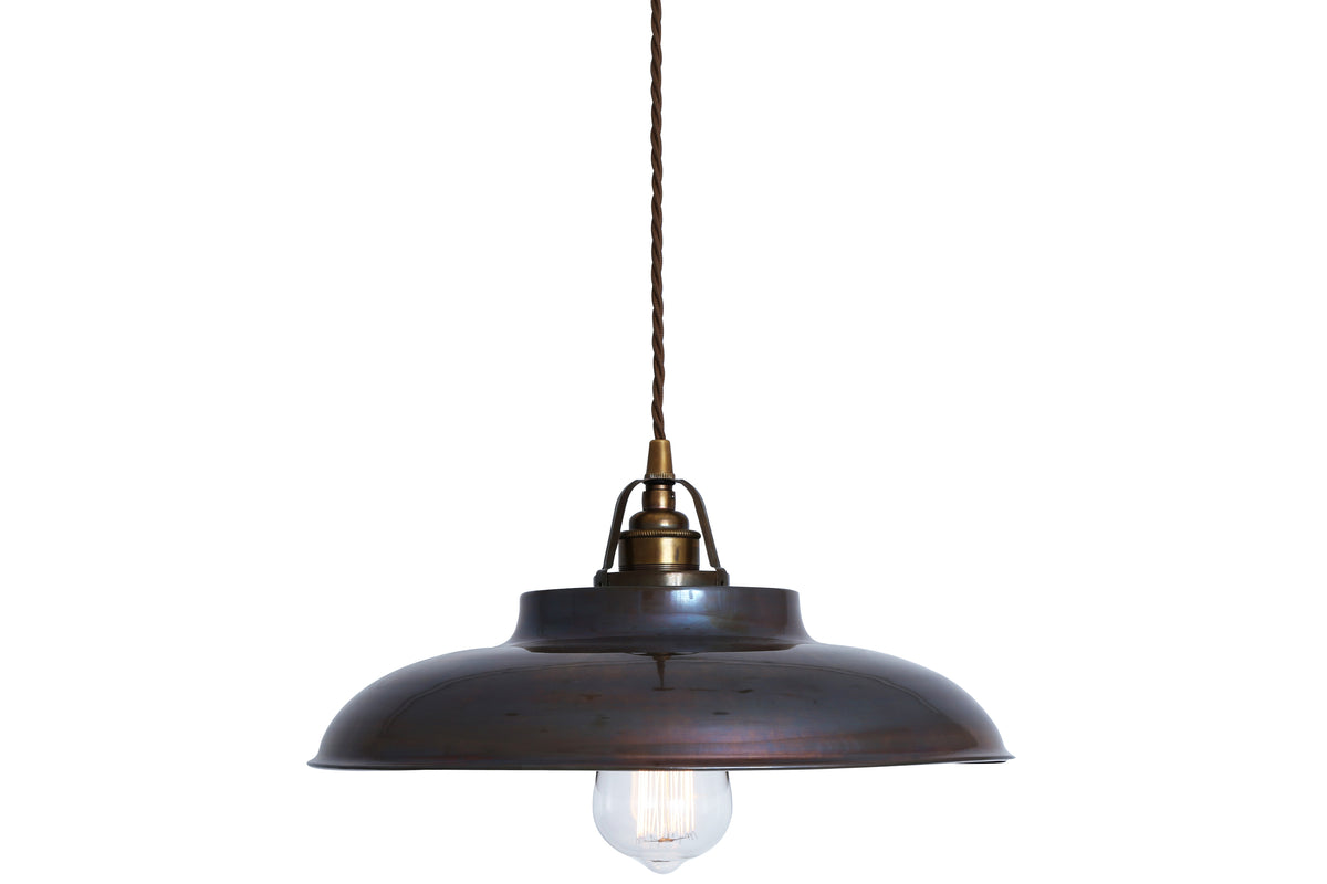 Industrial style dark bronze metal pendant light with an exposed Edison bulb and twisted fabric cord