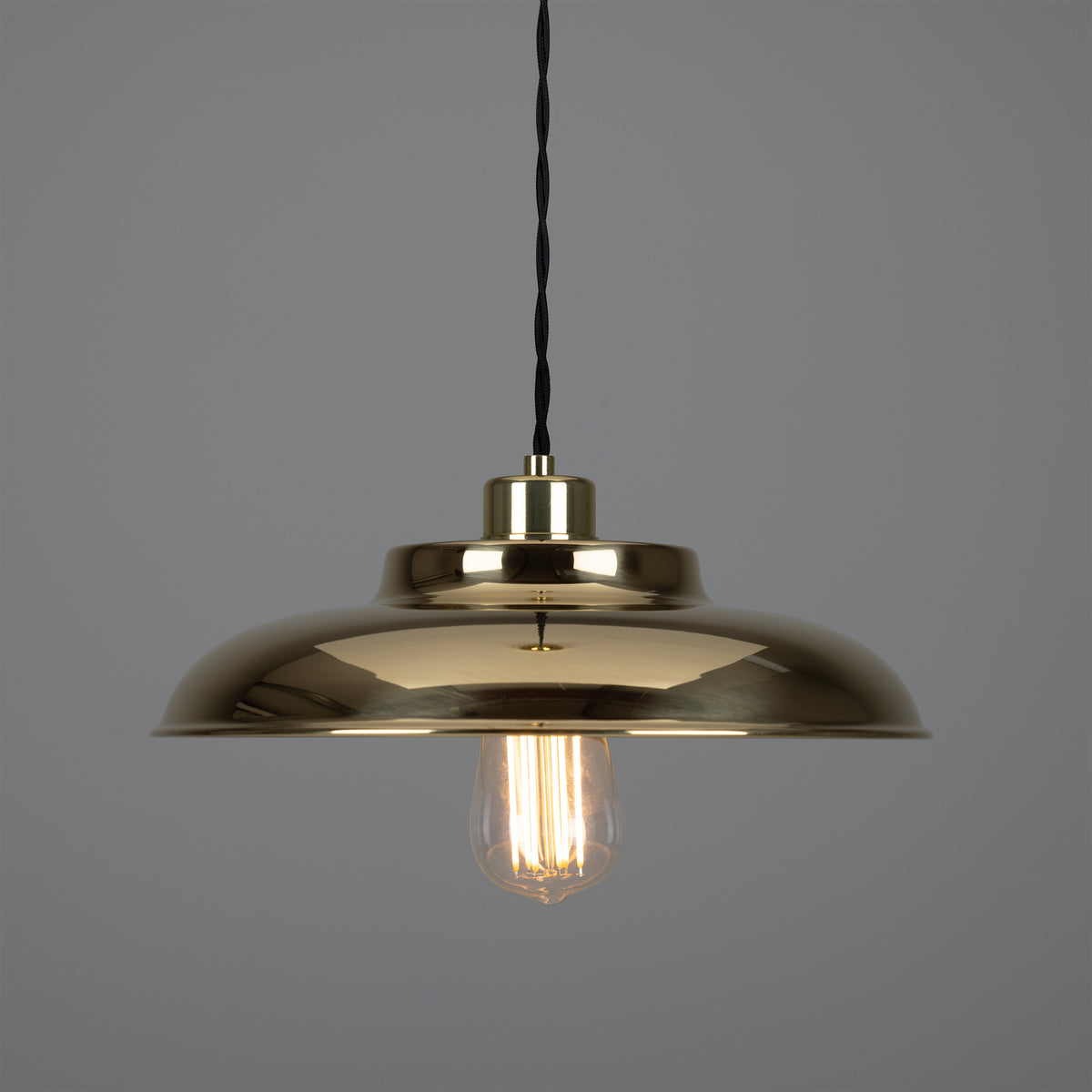 Polished brass dome pendant light with exposed filament bulb