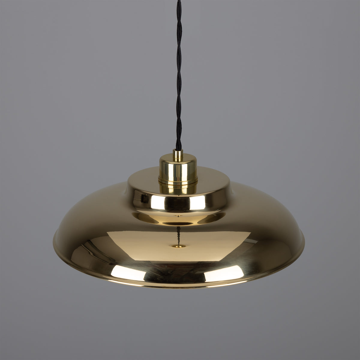 Polished brass dome pendant light with black fabric cord