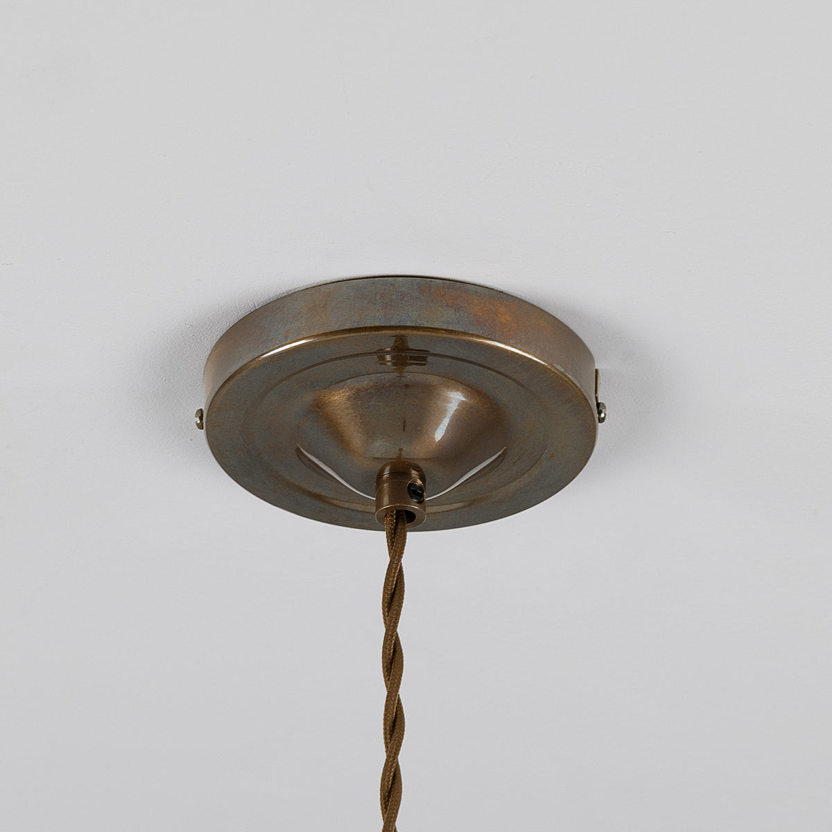 Round antique brass ceiling canopy with twisted fabric cord