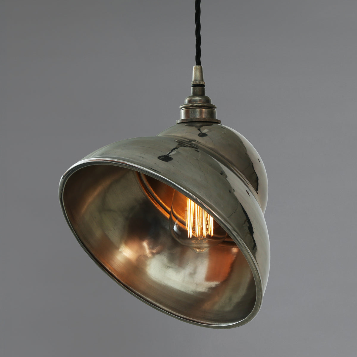 Polished nickel dome pendant light with exposed filament bulb