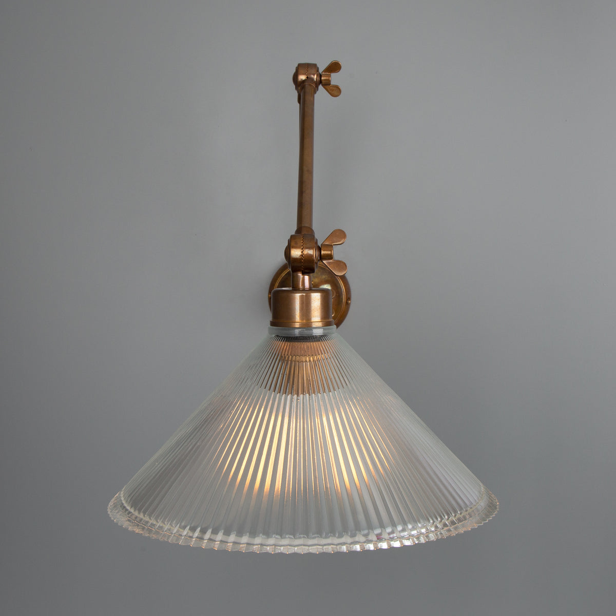 Rebell Adjustable Arm Wall Light in Antique Brass with Prismatic Glass Shade