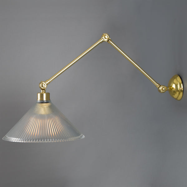 Brass swing arm wall lamp with a ribbed glass cone shade