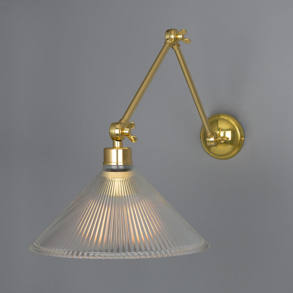Mullan Rebell adjustable arm wall light in polished brass with a conical prismatic glass shade