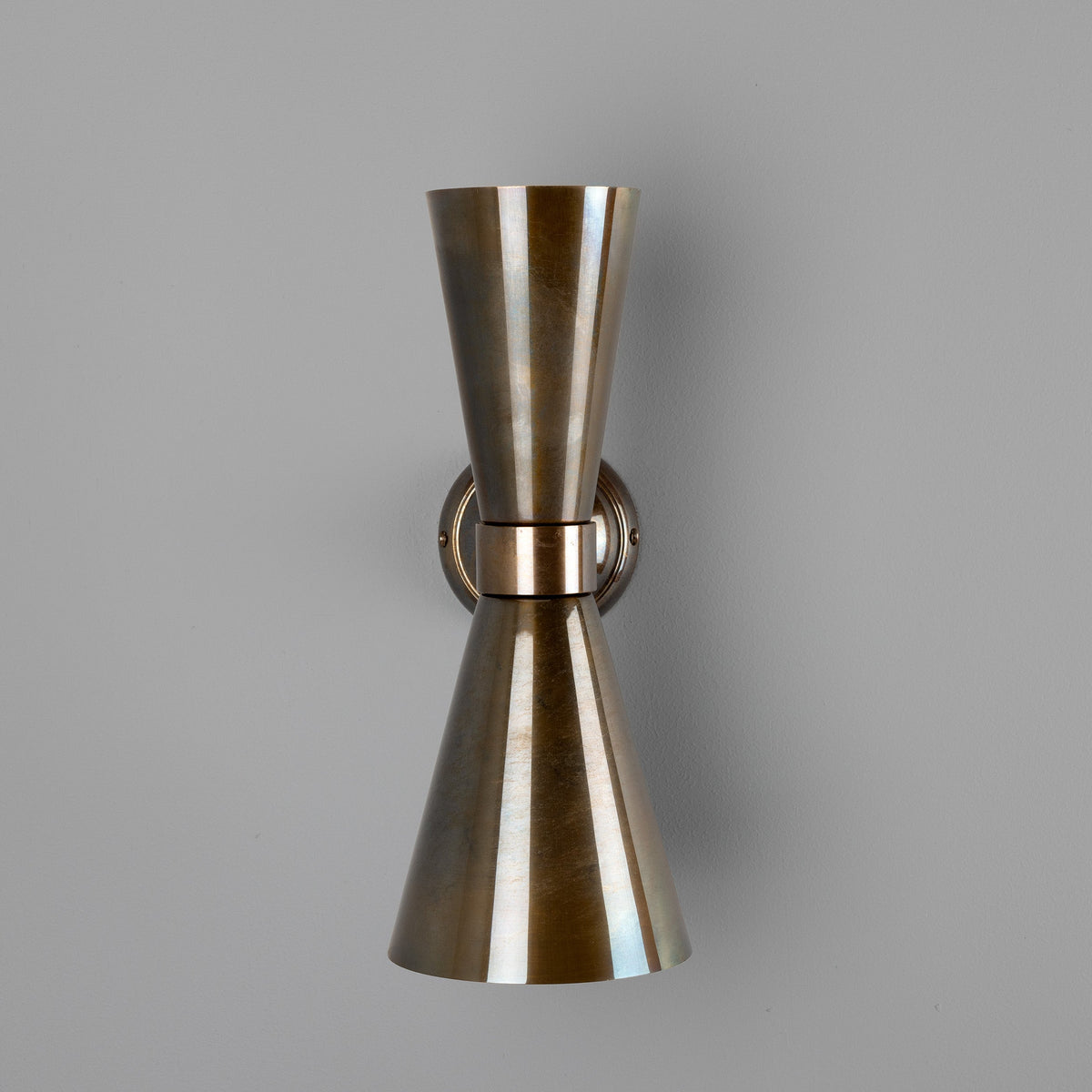 Double cone wall sconce in antique brass finish