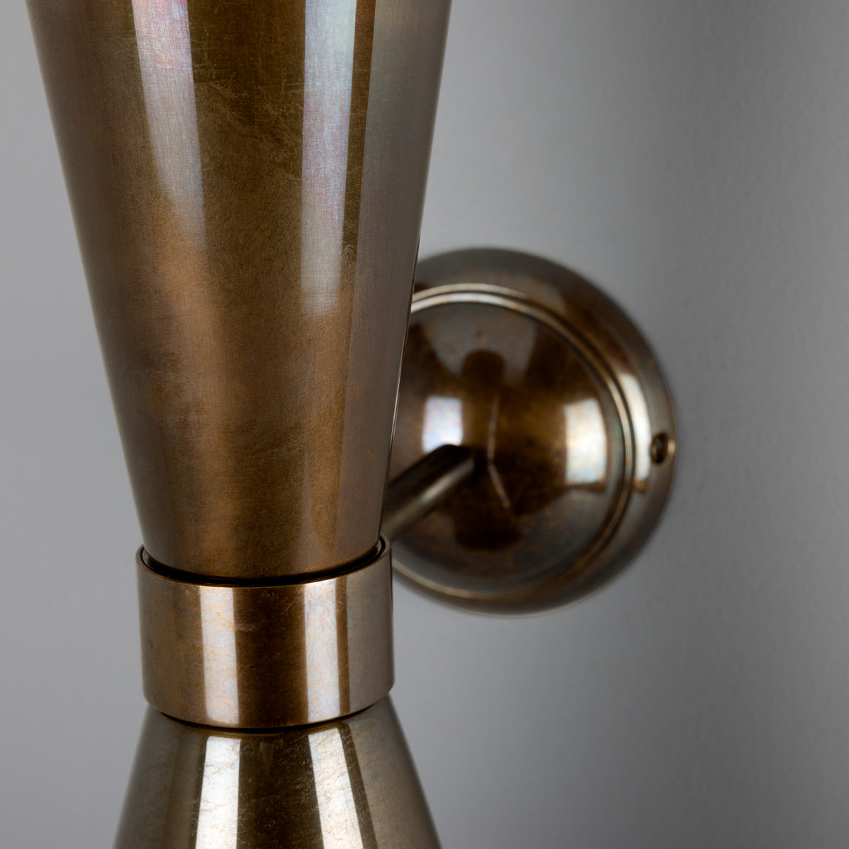 Antique brass wall sconce with dual conical shades