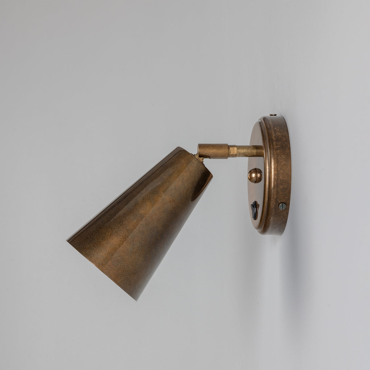 Cashel Adjustable Switched Brass Cone Wall Light in Antique Brass