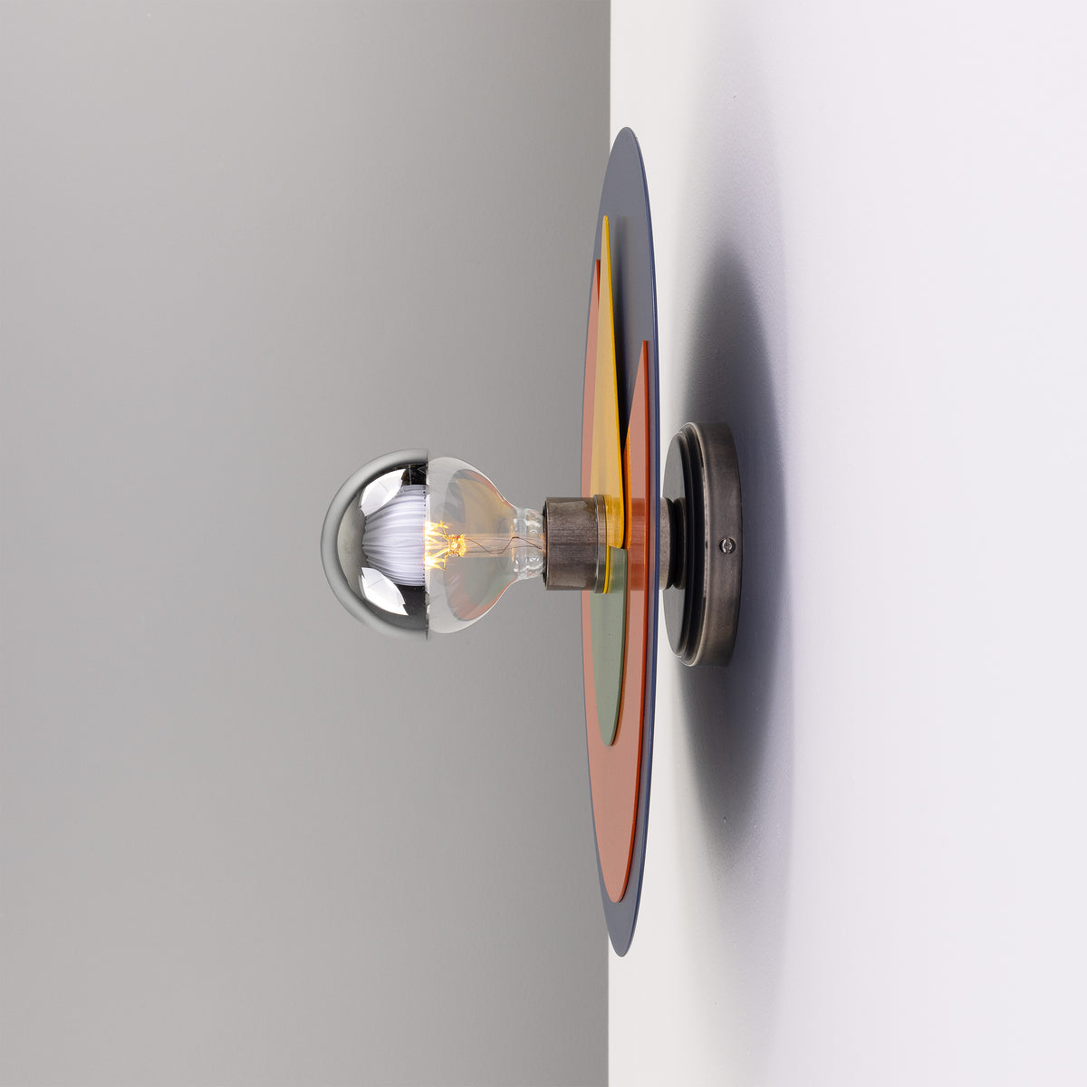 Mullan Neptune colourful disc wall light in antique silver with a silver tipped bulb