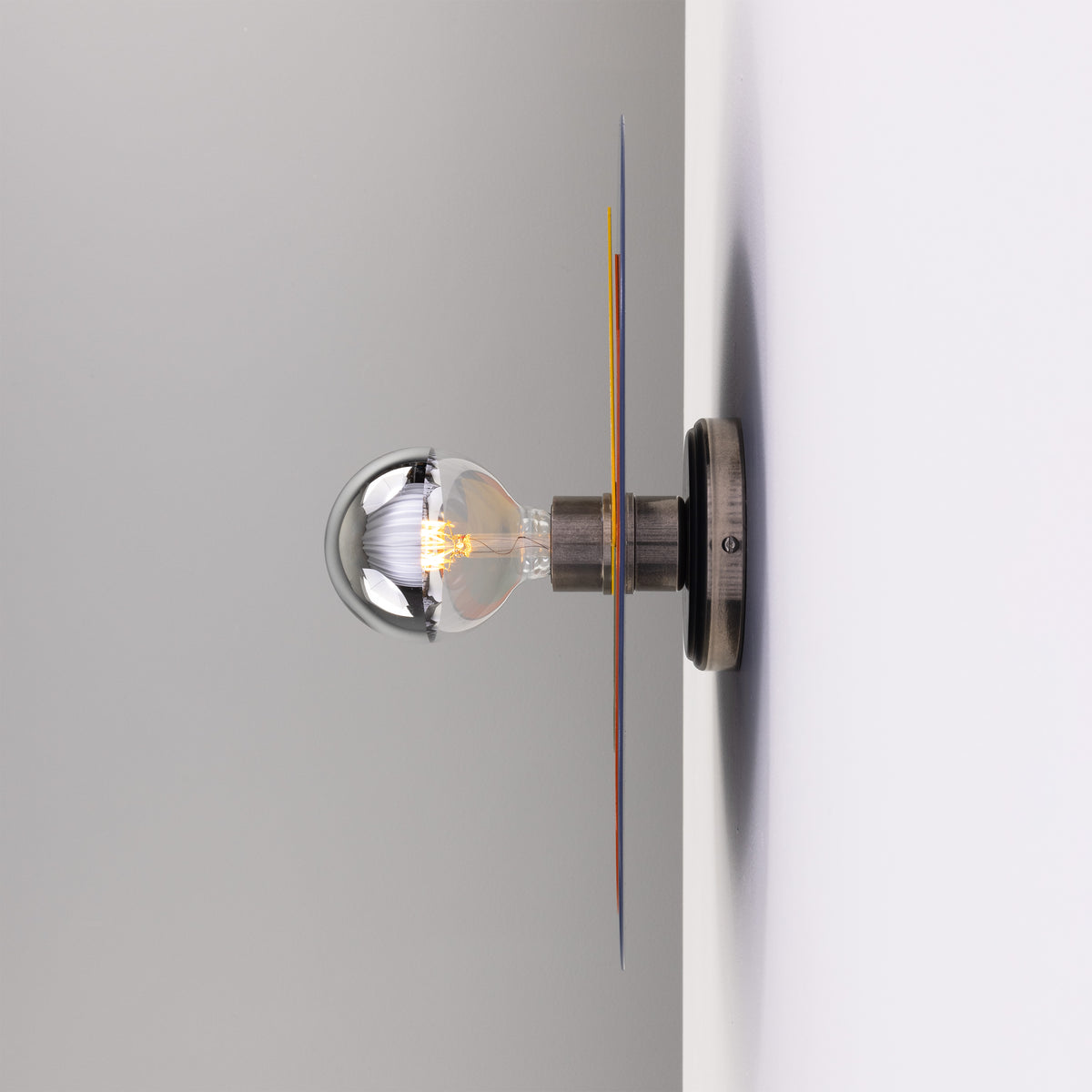 Mullan Neptune colourful disc wall light in antique silver with a decorative globe bulb