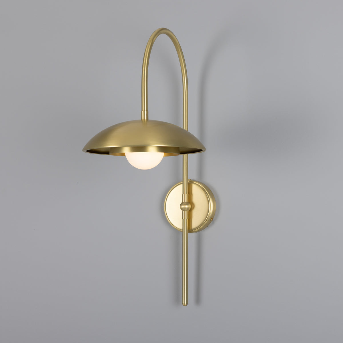 Mullan Marrakesh Art Deco arc wall light in satin brass with a dome shade and globe bulb