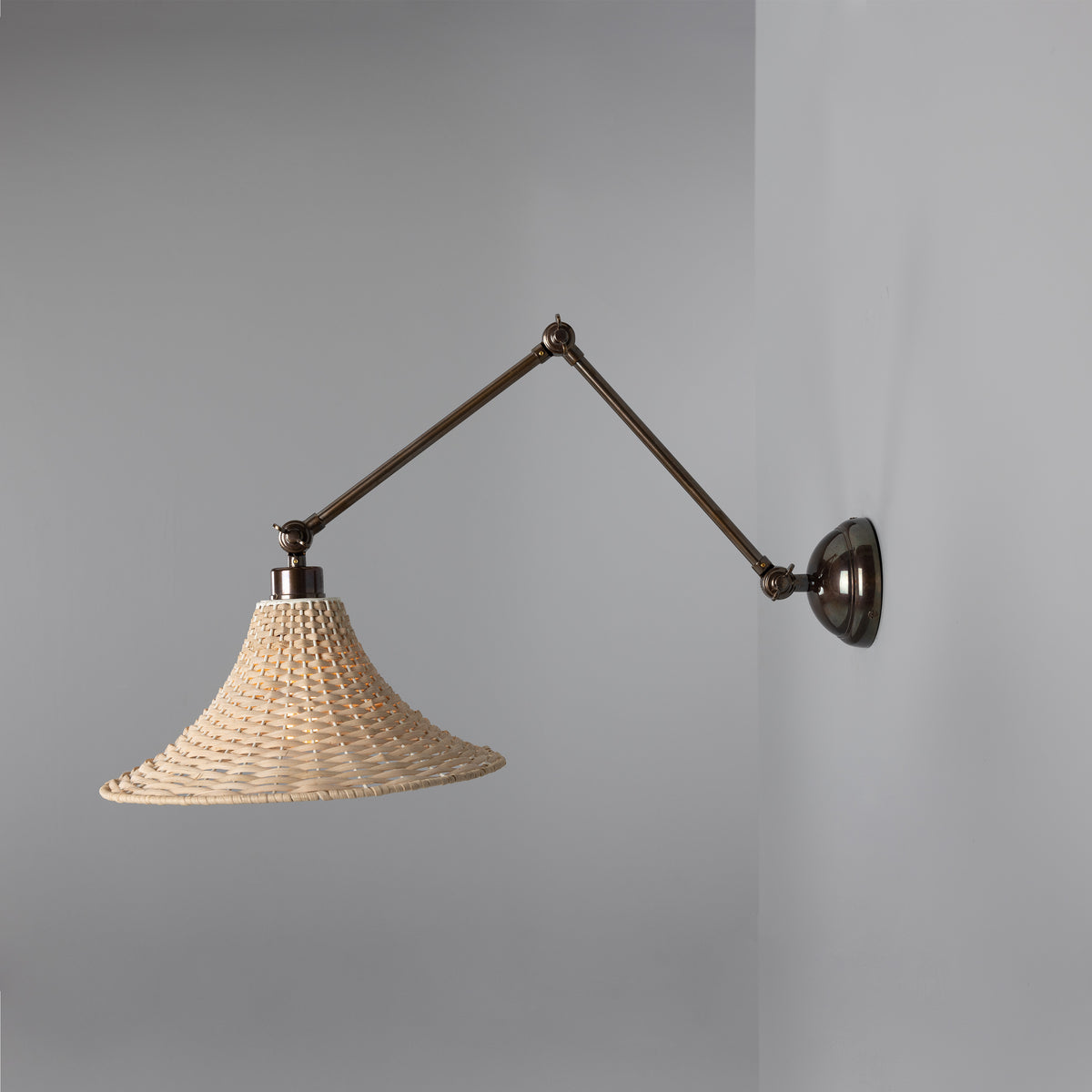 Savannah Adjustable Arm Wall Light in Antique Brass with Large Bell Shaped Rattan Shade