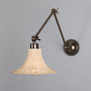 Savannah Adjustable Arm Wall Light in Antique Brass with Small Bell Shaped Rattan Shade