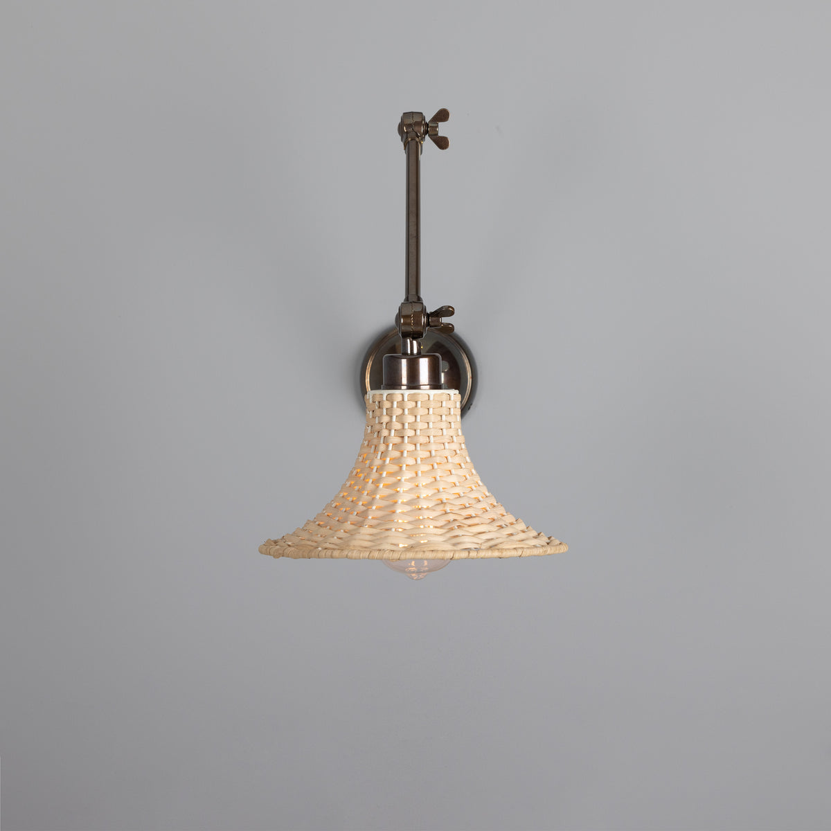 Savannah Adjustable Arm Wall Light in Antique Brass with Small Bell Shaped Rattan Shade