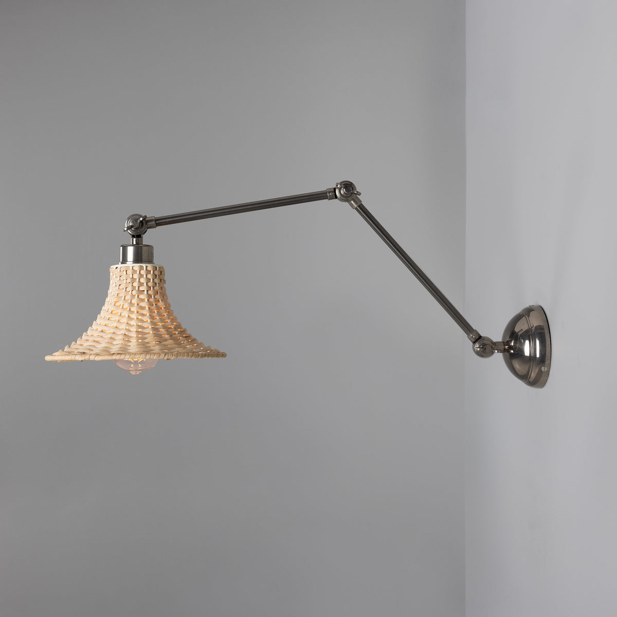 Savannah Adjustable Arm Wall Light in Antique Silver with Small Bell Shaped Rattan Shade