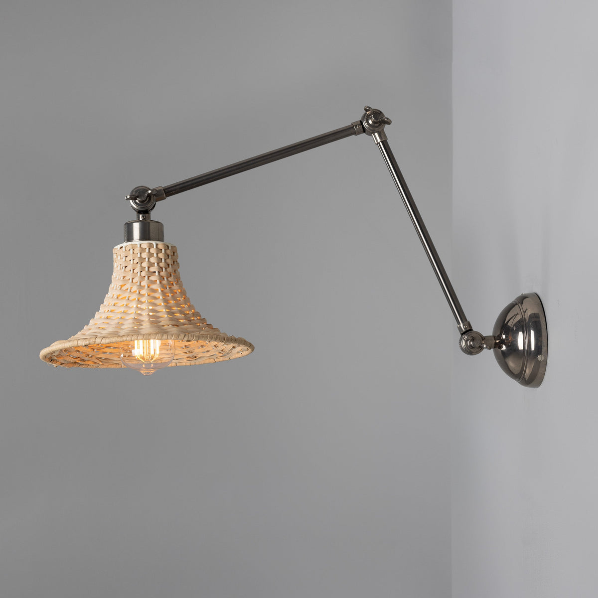 Savannah Adjustable Arm Wall Light in Antique Silver with Small Bell Shaped Rattan Shade