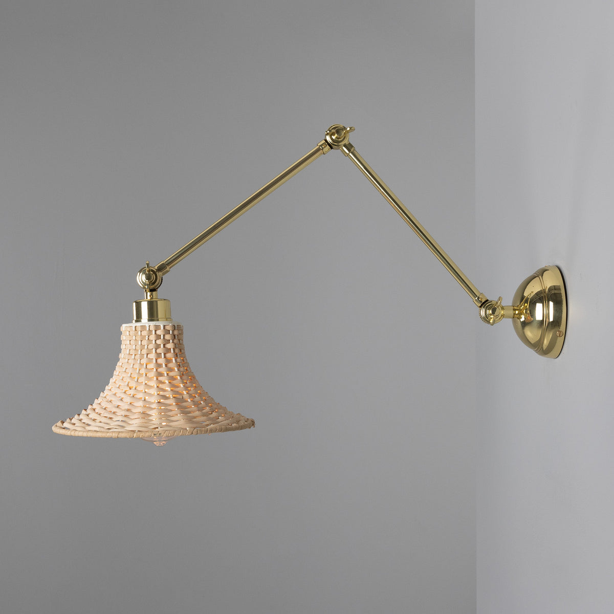 Savannah Adjustable Arm Wall Light in Polished Brass with Small Bell Shaped Rattan Shade